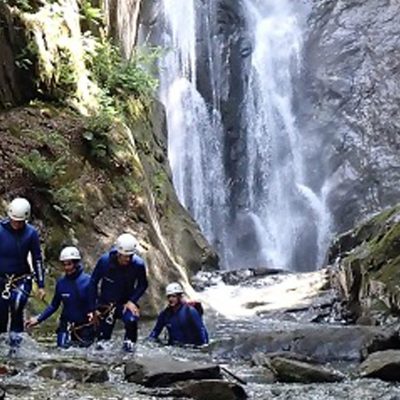 large waterfall with canyoneers