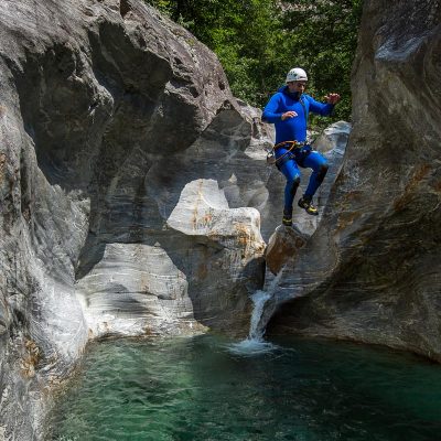 jumping into green pool on family canyoning tour